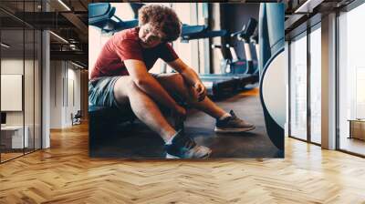 Tired fat man thinking over weight problems, desire to lose weight, gym workout Wall mural