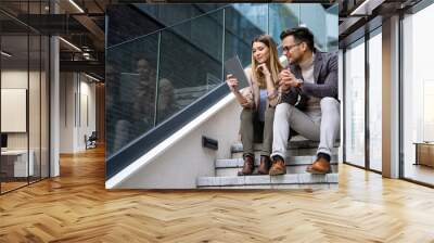 Two creative business people working on social media strategy using a digital tablet Wall mural