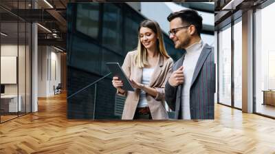 Two creative business people working on social media strategy using a digital tablet Wall mural