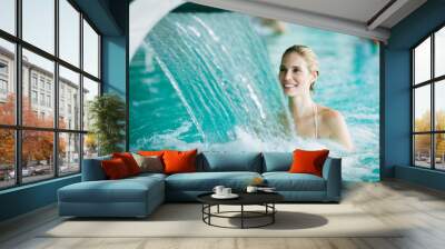 Woman enjoying hydrotherapy in spa pool Wall mural