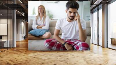 Worried couple having problems in bedroom Wall mural