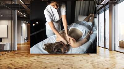 Young and healthy woman in spa salon. Traditional Swedish massage therapy Wall mural