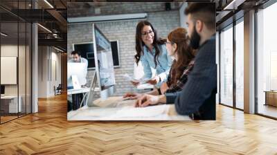 Young architects working on project in office Wall mural