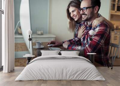 Young couple of designers working on computer Wall mural