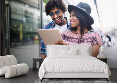 Young couple shopping on internet with tablet Wall mural