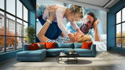 Young family being playful at home. People parent child fun happiness concept. Wall mural