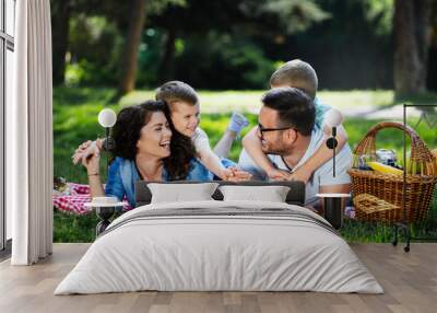 Young family with children having fun in nature Wall mural