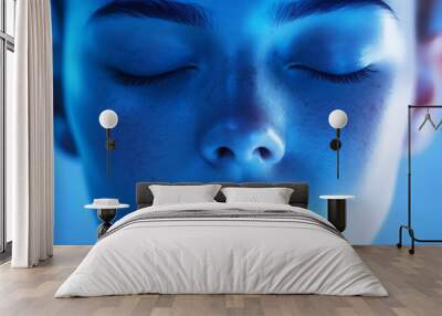 Close-up portrait of a woman's face with closed eyes. Wall mural