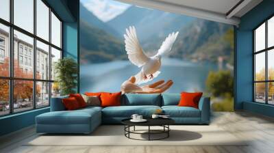 A hand releasing a white pigeon in a natural scenic background, symbolizing peace and freedom. Suitable for international day of peace promotions and concept designs. Wall mural