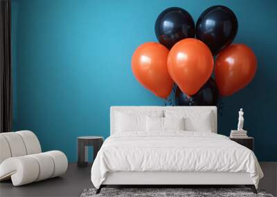 Black and orange balloons on blue background, perfect for a Halloween or birthday party with copy space for adding text or design. Wall mural