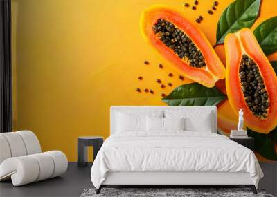 Cut papaya over orange table background for tropical fruit design concept. Top view with copy space. Ideal for healthy lifestyle, nutrition, and summer-themed designs. Wall mural