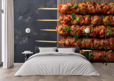 Top view of raw kofta or lula kebabs skewers on a butcher board with a gray background, perfect for cooking and grilling events or for a homemade appetizer. Wall mural