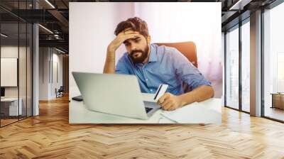 handsome man feeling disappointed because he misses a chance to buy cheap stuff on auction. online s Wall mural