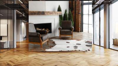 Side view of spacious white country house interior in eco style with teo chairs and fireplace Wall mural