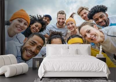 A group of friends of diverse ethnicities smiles and looks directly at the camera after an outdoor adventure. Wall mural