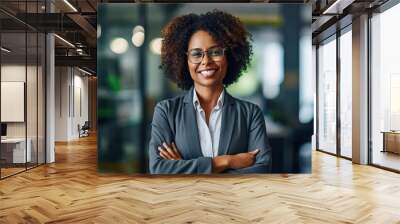 A smiling  business afro woman ceo wearing glasses Happy middle aged business woman ceo standing in office with arms crossed. Smiling mature confident professional executive manager, proud lawyer, bus Wall mural