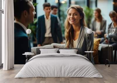 A woman leading a business break with a group of people sitting on a couch Wall mural