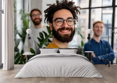 Three friends smiling together in a bright indoor space Wall mural