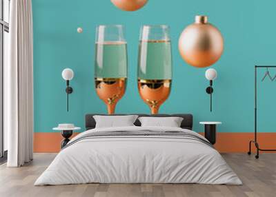 Two golden champagne glasses with celebration ornaments hovering above. Surreal New Year minimal concept Wall mural