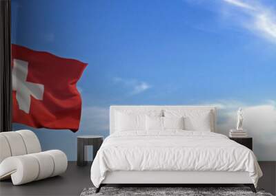 Flag of Switzerland rise waving to the wind with sky in the background Wall mural