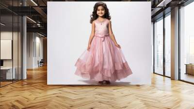 Cute indian little girl child in pink color lehenga choli on white background Wall mural