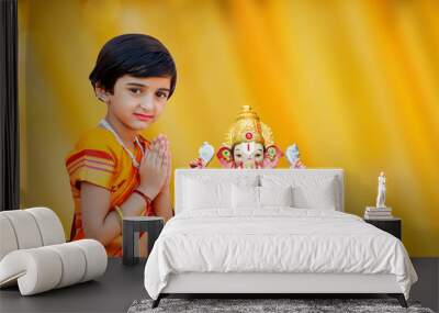 Little Indian girl child with lord ganesha and praying , Indian ganesh festival Wall mural