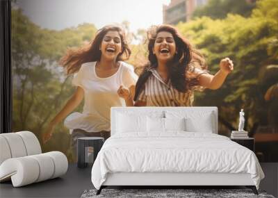 Two Indian college girls or sisters laughing and having fun Wall mural