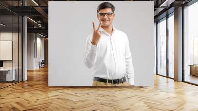 Young Indian man showing victory sign  Wall mural