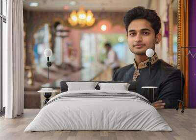 young indian man standing in salon Wall mural