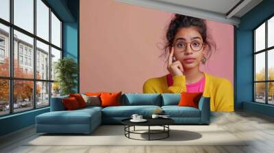 young indian woman giving thinking expression Wall mural