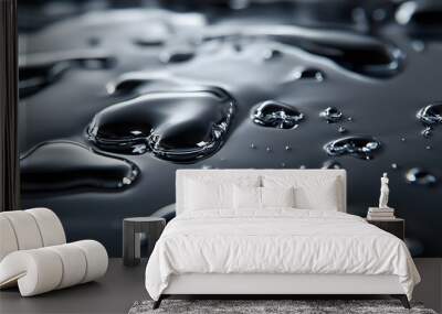 Liquid Mercury: A close-up of liquid mercury droplets merging on a reflective surface, with high contrast between the silver liquid and a dark background.  Wall mural