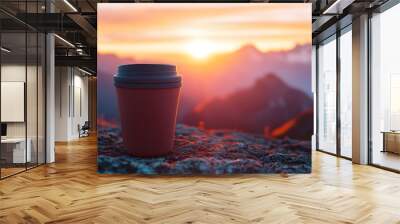 Travel Mug: A travel mug filled with coffee, with a beautiful sunrise over a mountain range in the background.
 Wall mural