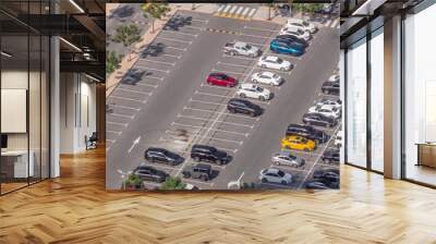 Aerial view of many colorful cars parked on parking lot with lines and markings for parking places timelapse. Dubai Wall mural