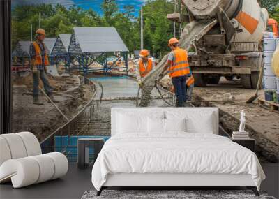 Concrete works for road construction with many workers and mixer timelapse Wall mural