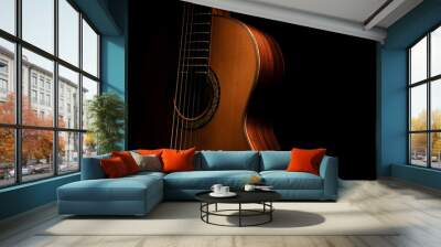 Classical guitar close up, dramatically lit on a black background with copy space. Wall mural