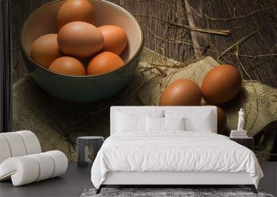 Eggs in a bowl and on hessian sacking with scattered straw Wall mural