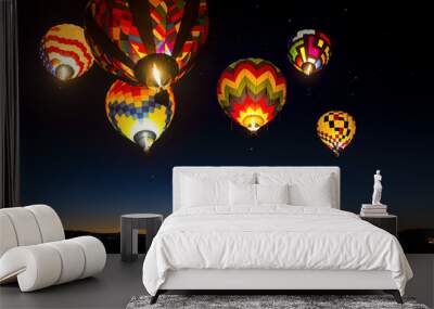 colorful hot air balloons at dawn lit up in the sky. Wall mural