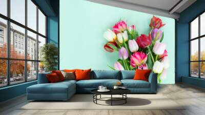 Bunch of fresh tulips flowers on pastel green background with copy space Wall mural