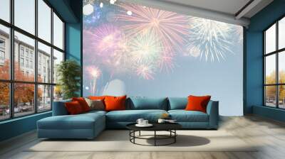 Fireworks colorful explosions on blue, festive background with copy space Wall mural