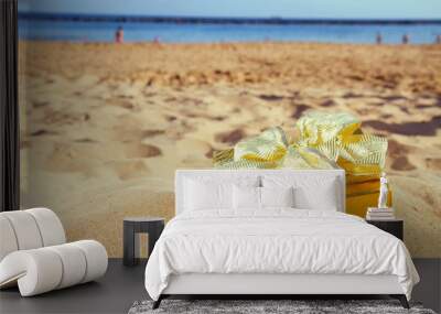 golden christmas gift on beach Wall mural