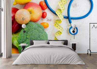 healthy diet concept, raw fresh vegetables with stethoscope on white wooden table Wall mural