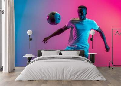 One African man professional soccer football player in training with flying ball Wall mural