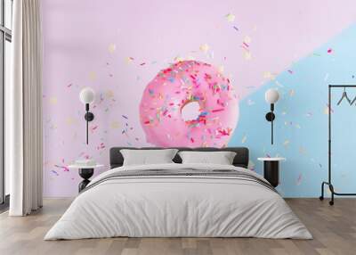 one falling sweet doughnut with sprinkles on blue and pink abstract background with copy space Wall mural