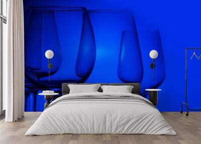 Set of wine glasses on blue background close up, banner Wall mural