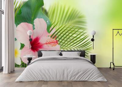 tropical fresh flowers and leaves - banner of fresh hibiscus and frangipani flowers and exotic palm leaves on green bokeh background Wall mural