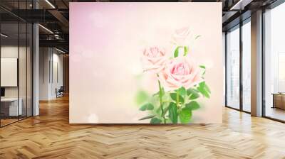 Two pink blooming fresh rose buds with green leaves on pink background with copy space Wall mural