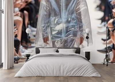 A black man models in a transparent cellophane outfit at a fashion show. Men's fashion week Wall mural