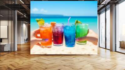 In a sunny and joyful atmosphere with a summer fun vibe, friends toast colorful drinks at the beach Wall mural