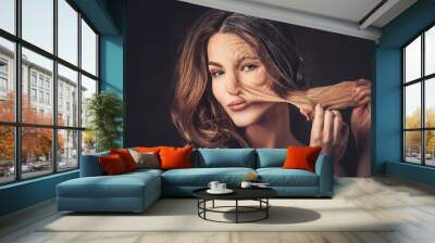 Aging and skin care concept. Half old half young woman, takes of Wall mural