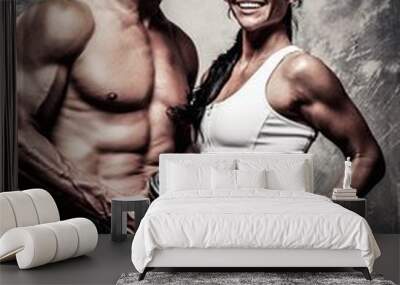 Athletic man and woman with a dumbbells Wall mural